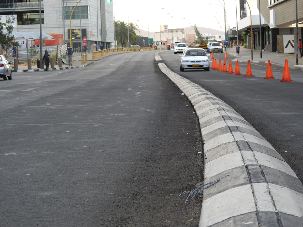 a road with orange cones on the side