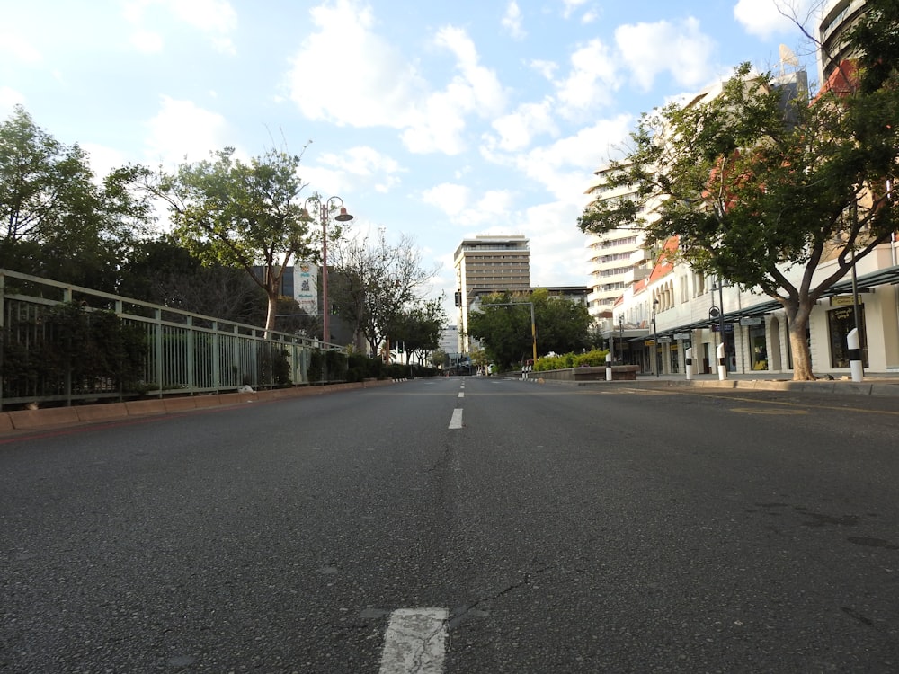 a street with trees and buildings on the side