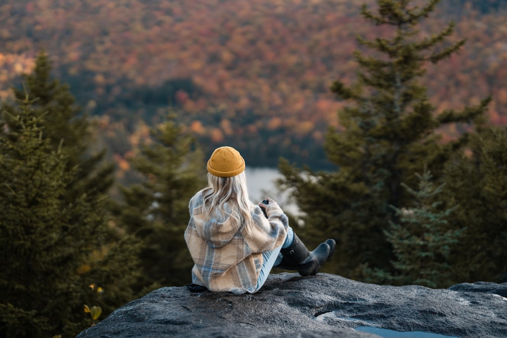 a person sitting on a rock