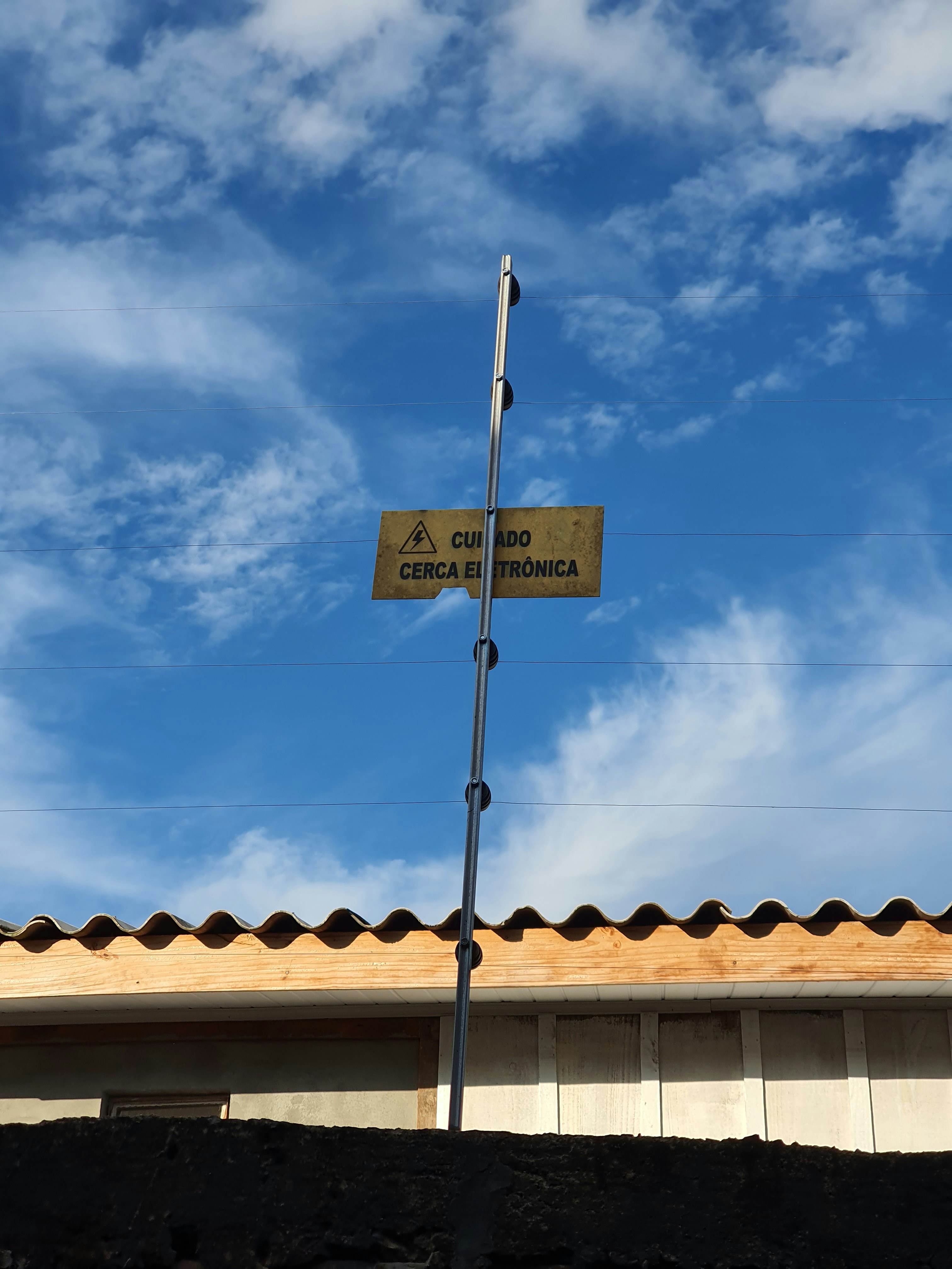 A sign on a pole photo – Free Sky Image on Unsplash
