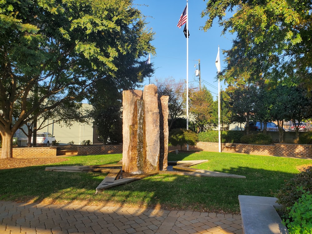 a stone statue in a park