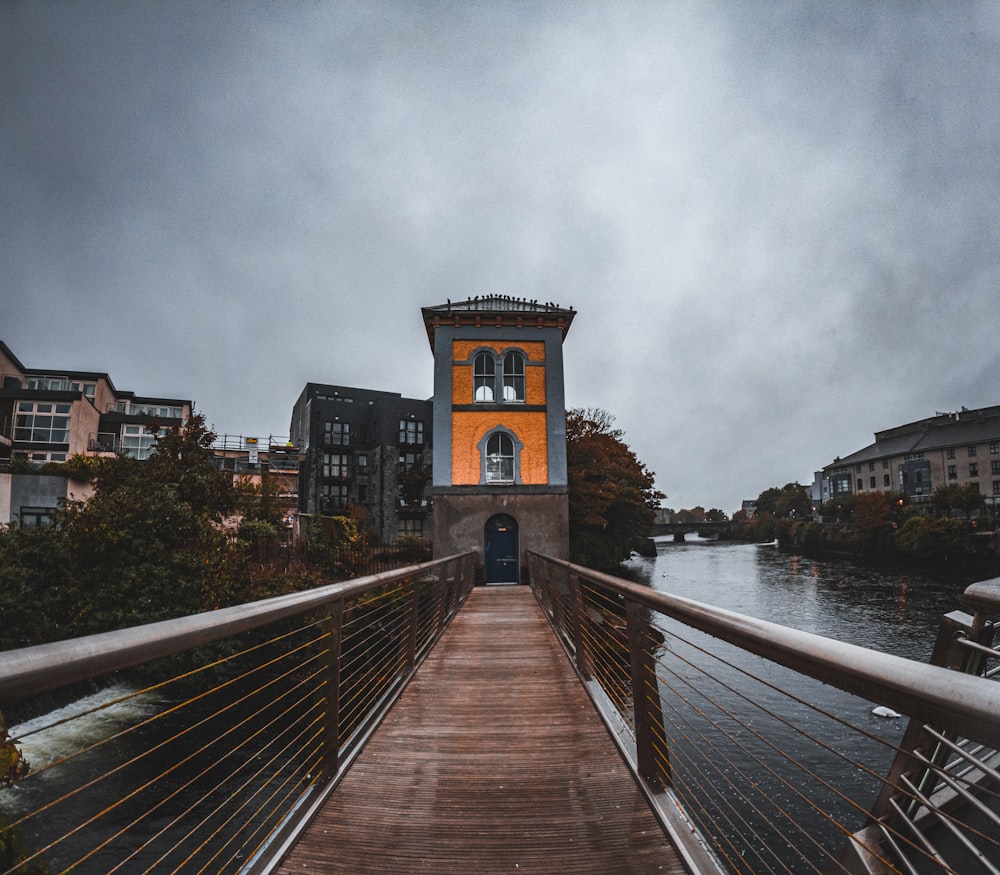 a wooden bridge over water with buildings on either side of it