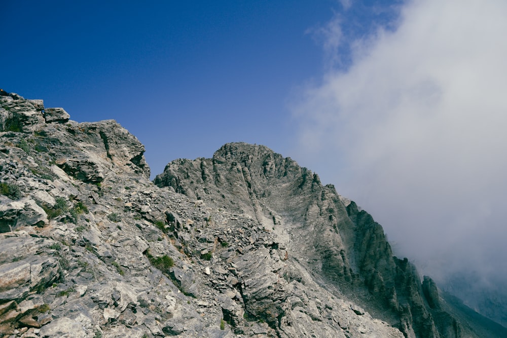 a rocky mountain with a blue sky