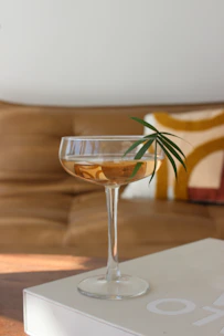 An open e-book on a tablet showing colorful cocktail recipes with garnishes.