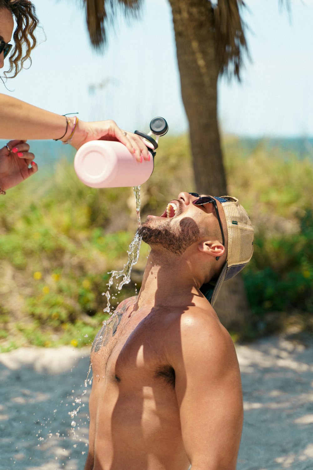 a woman drinking from a bottle