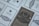 Multiple documents are arranged with a design featuring Cyrillic text and emblems, suggesting financial or official papers. The central document has decorative elements, including an emblem with a shield and foliage.