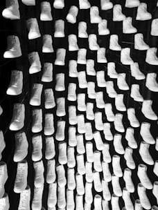 An array of footwear displayed on a clean, minimalist background.