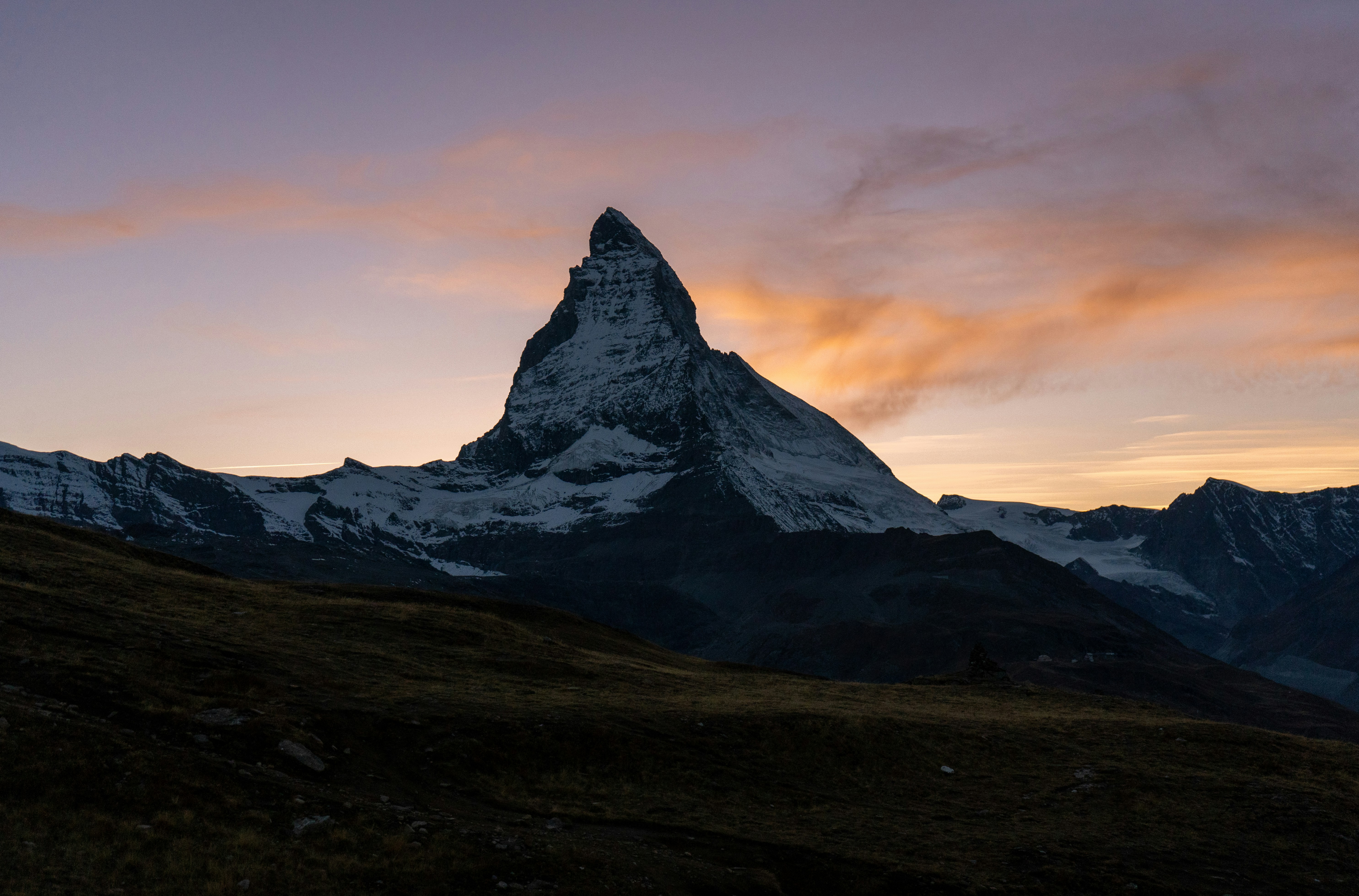 a snowy mountain with a sunset with Matterhorn in the background, 