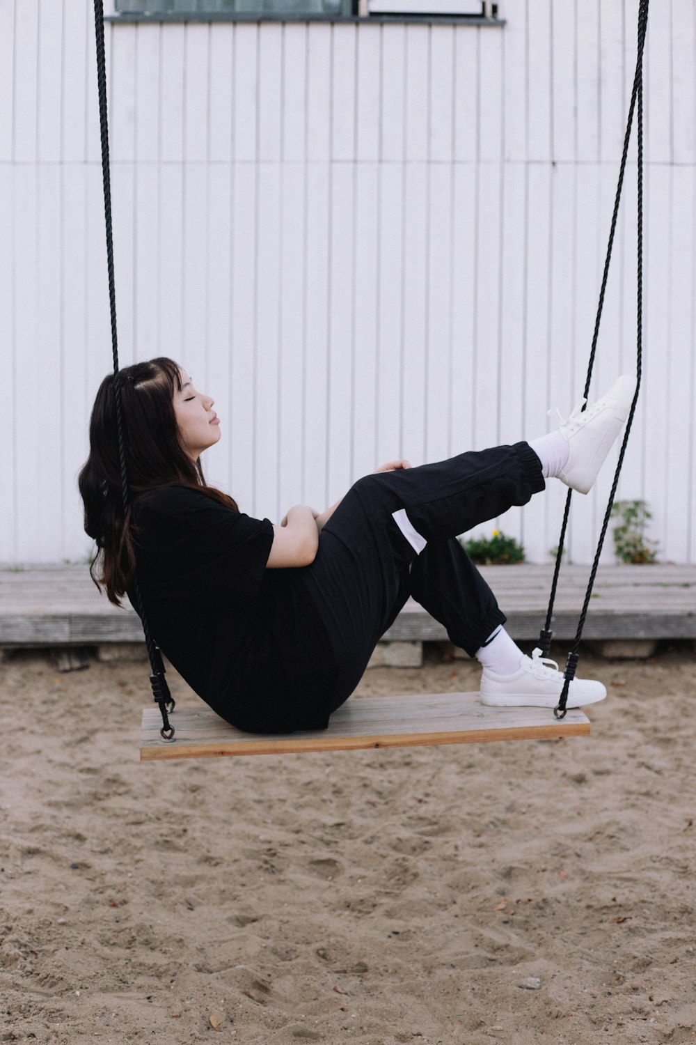 a person sitting on a swing