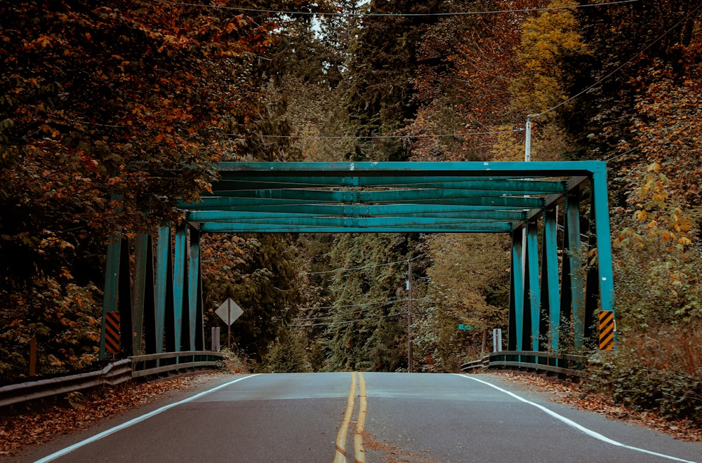 a road with a blue covered bridge over it