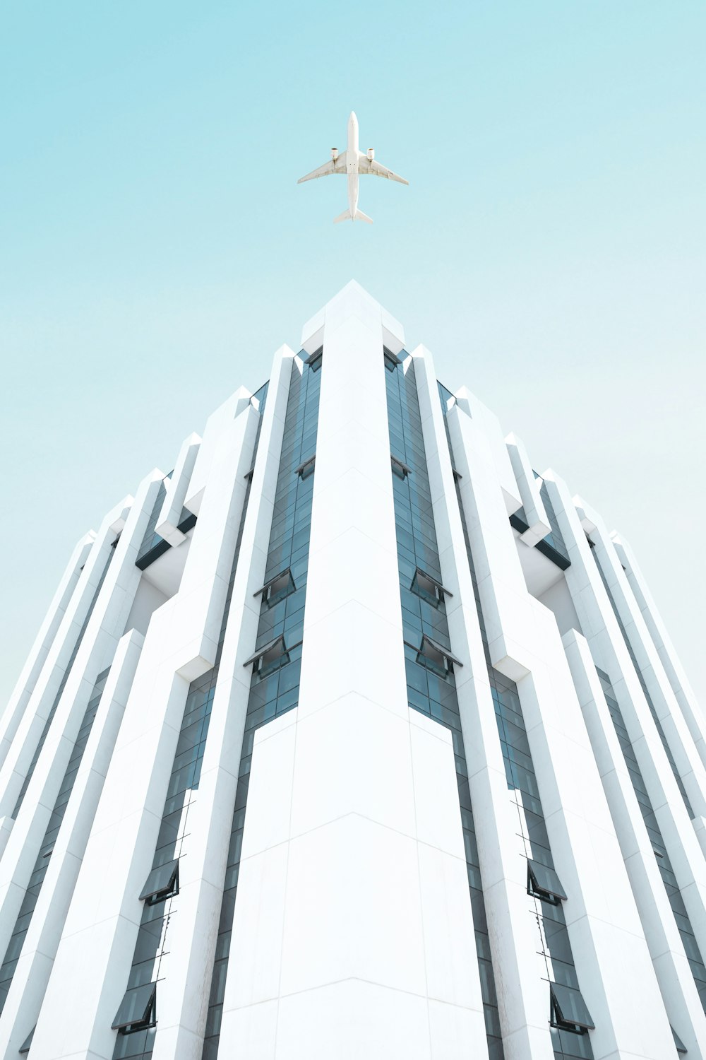 a plane flying over a tall building