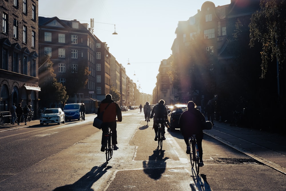 a group of people riding bikes down a street