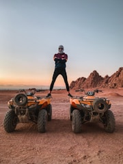 a man standing on two vehicles