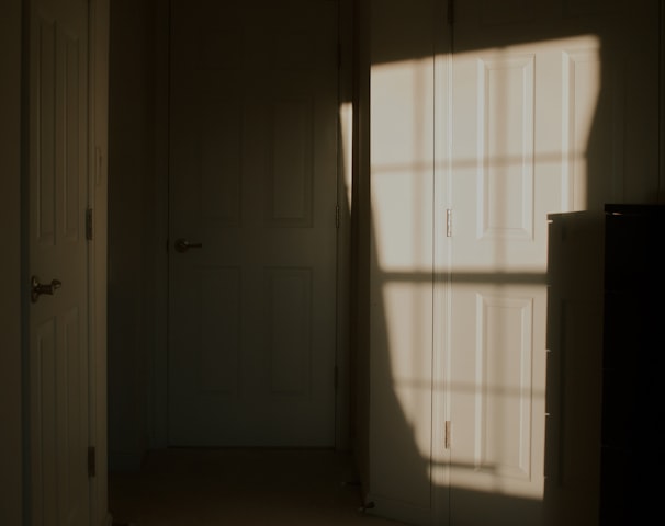 a dark room with white doors