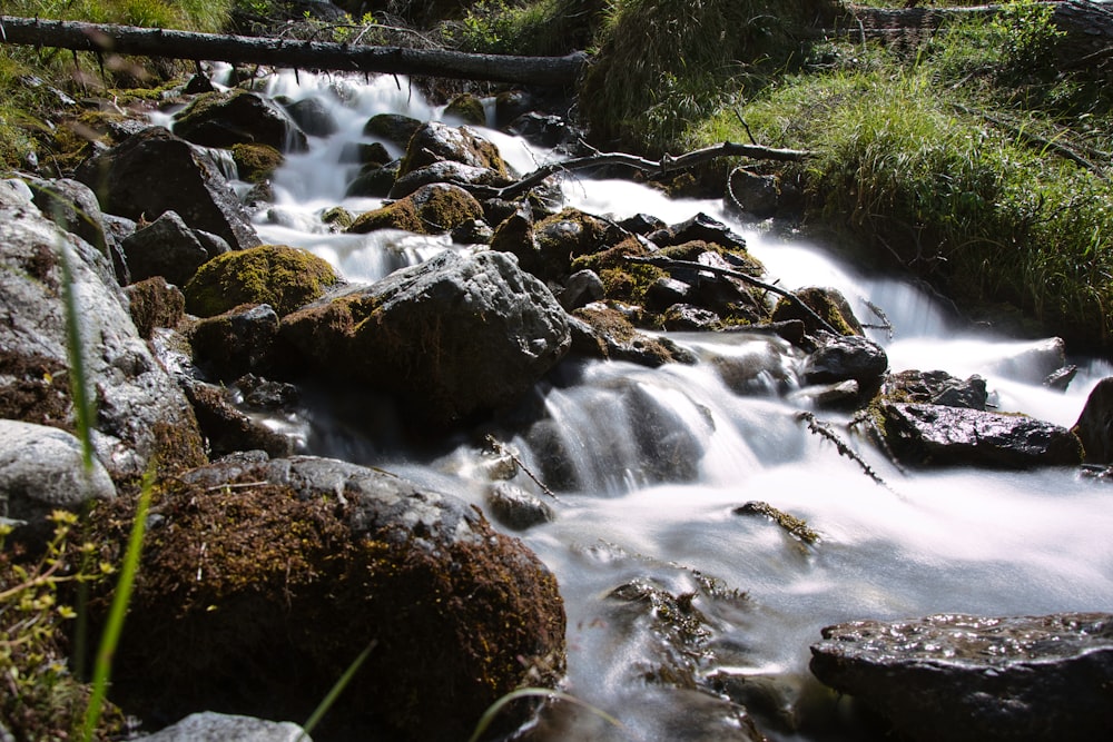 a stream of water flowing through rocks