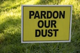 a yellow sign in the grass