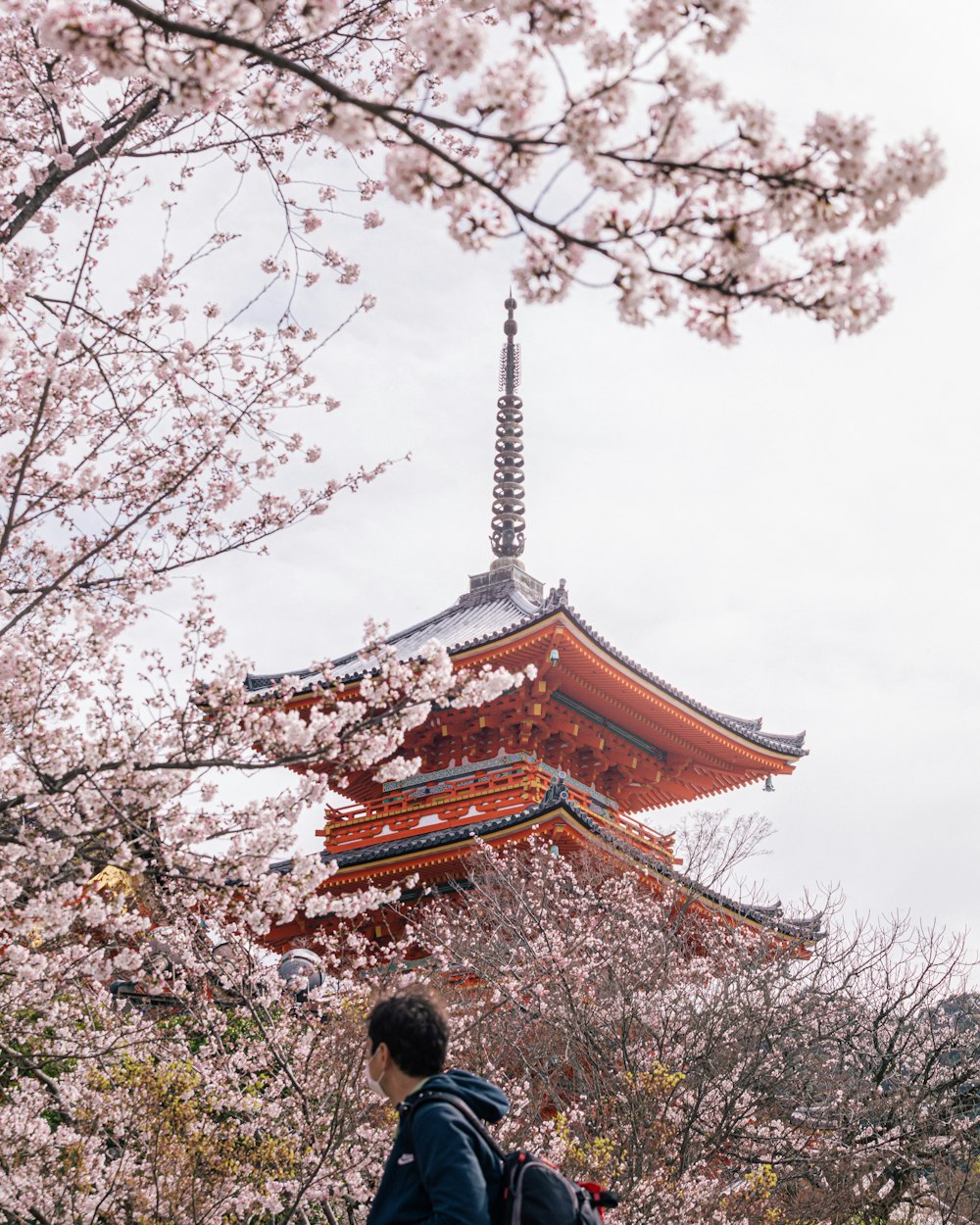 a man walking towards a tower