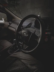 Inside view showing leather seats and ambient gold lighting of a Ford Expedition XL at night.