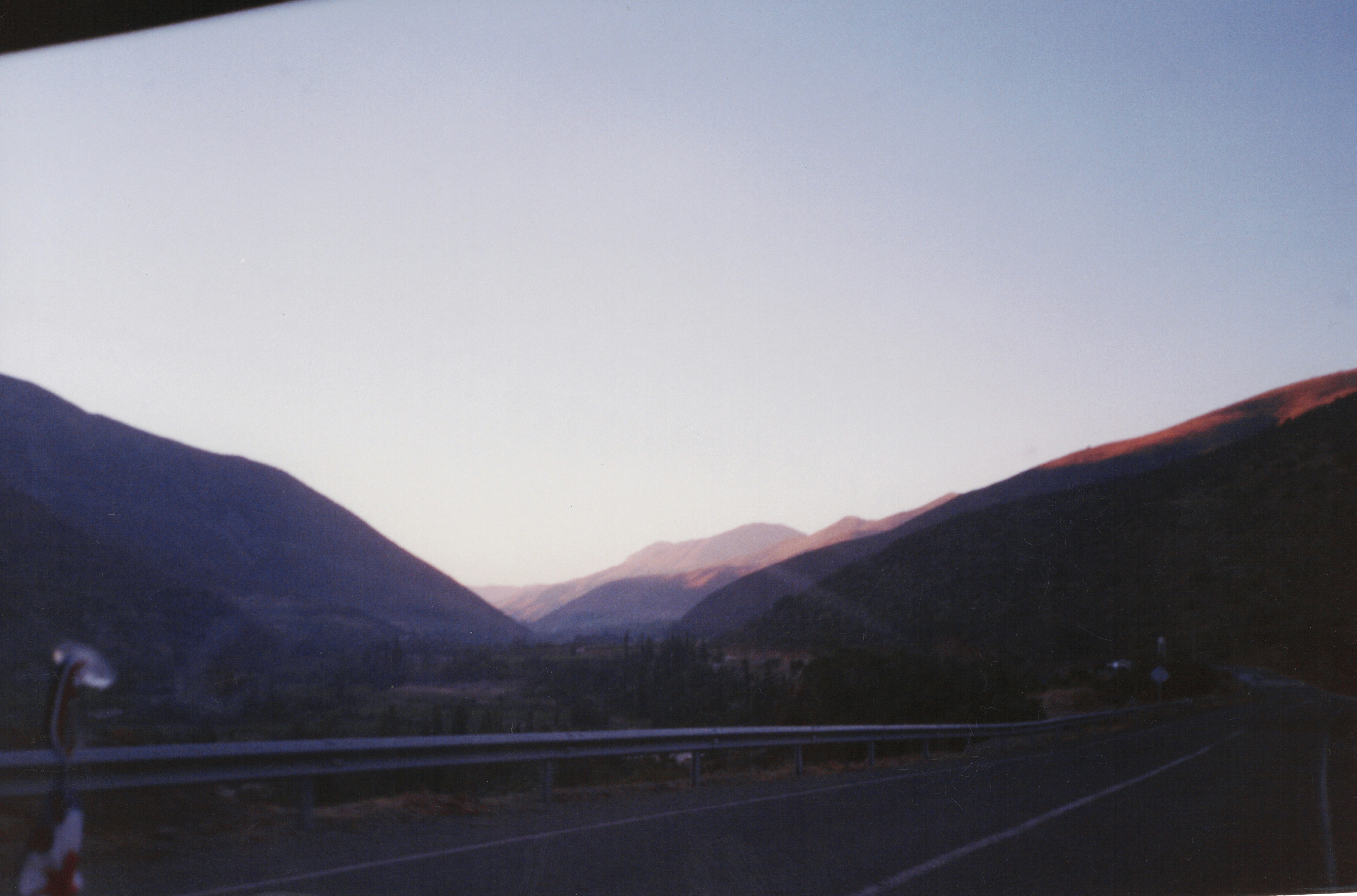 a road with mountains in the background