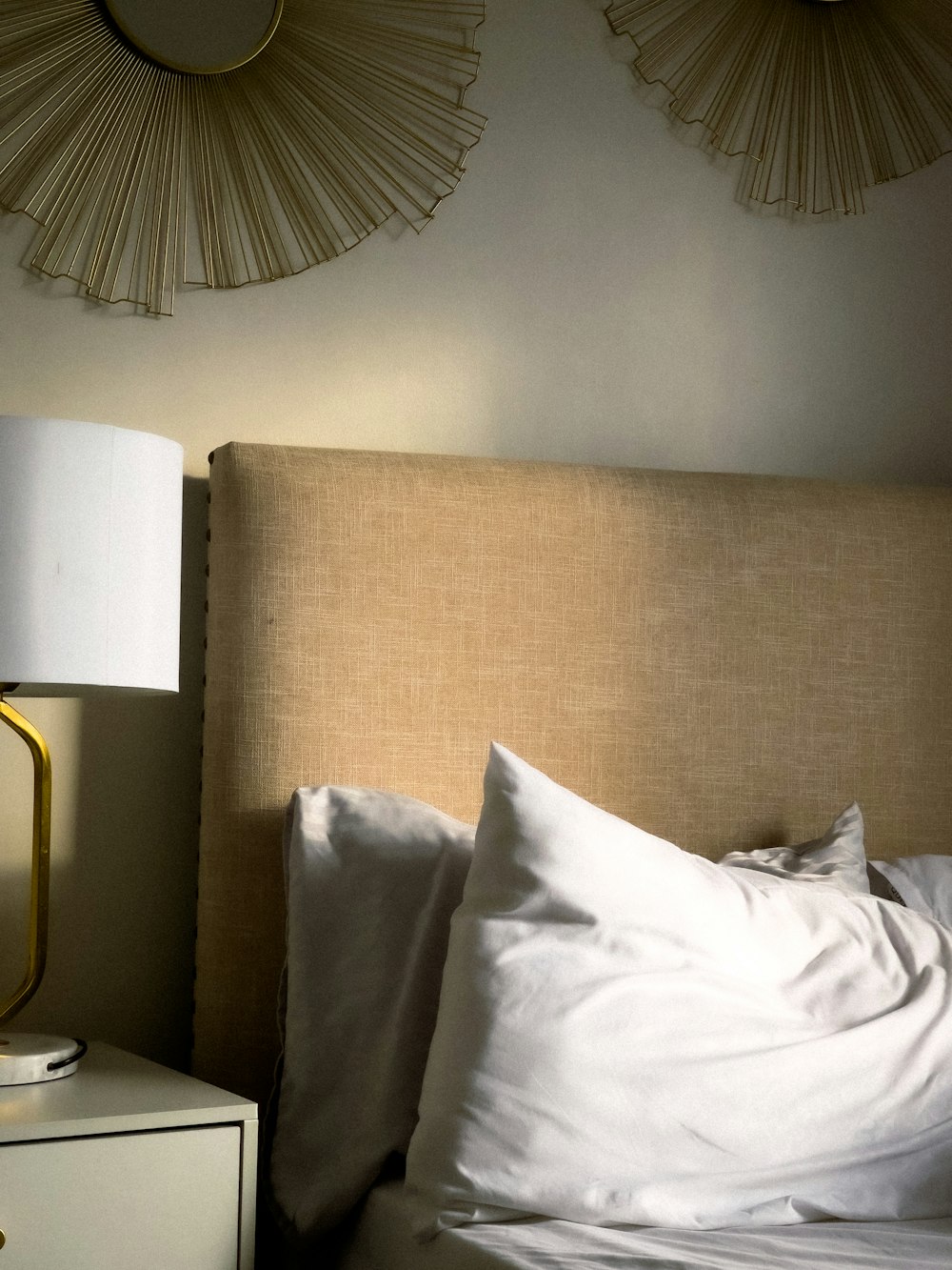a bed with a lamp and a pillow