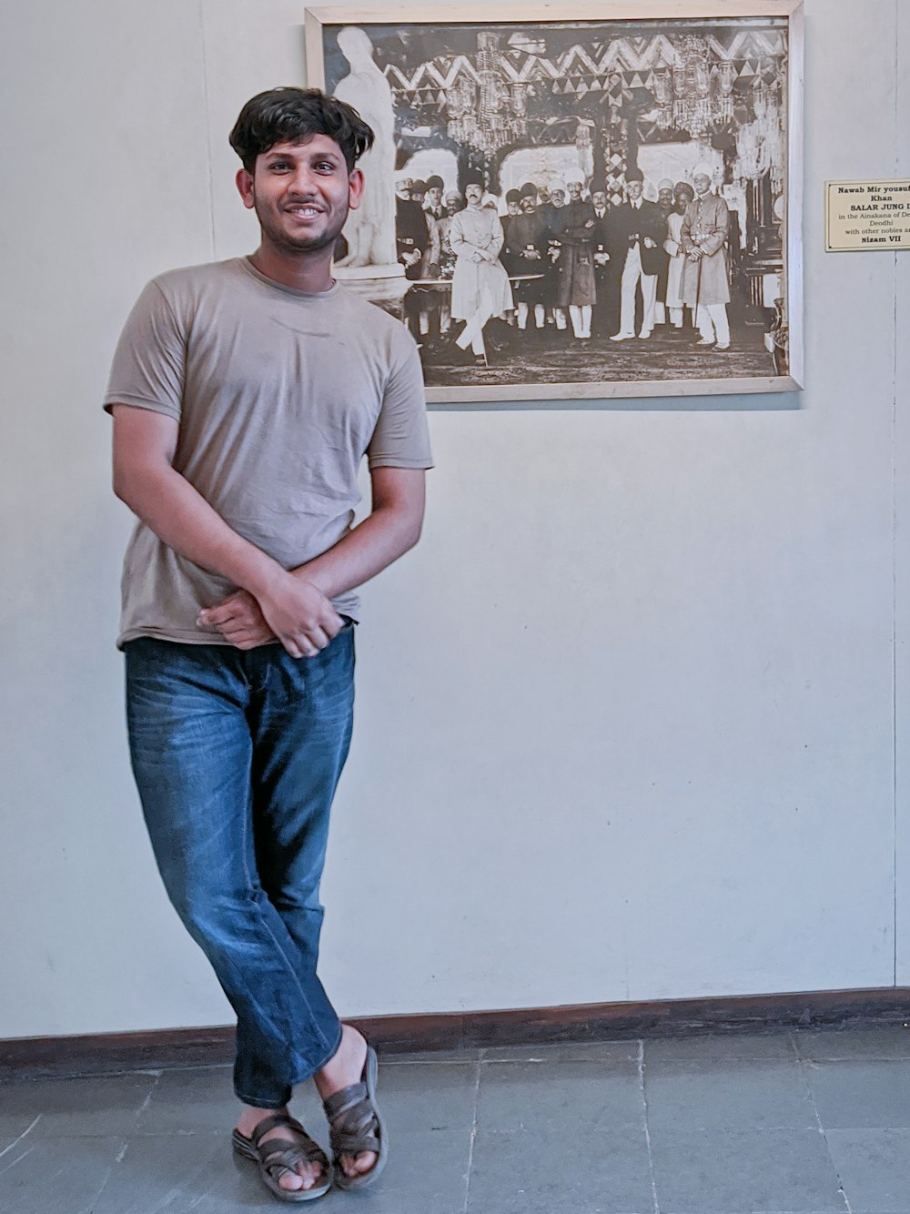um homem em pé na frente de uma pintura