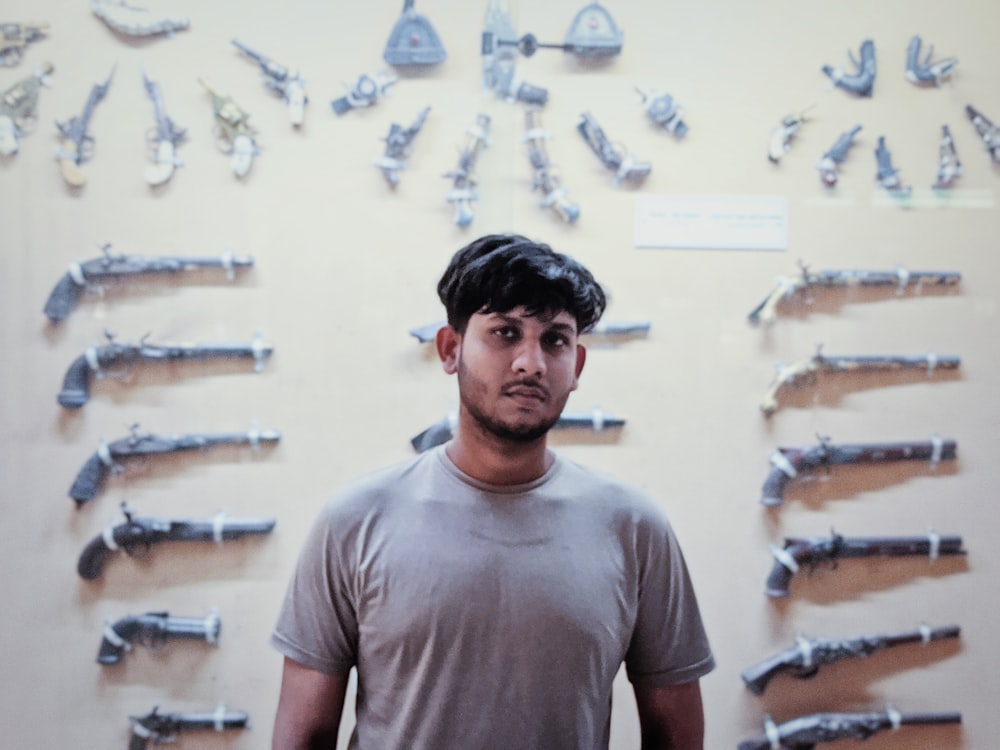 a man standing in front of a wall of fish