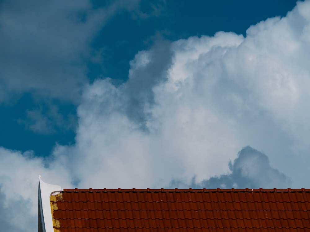 a roof with clouds above it