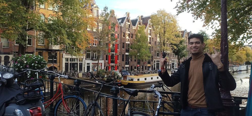 a person standing next to a bike rack with a boat in the background