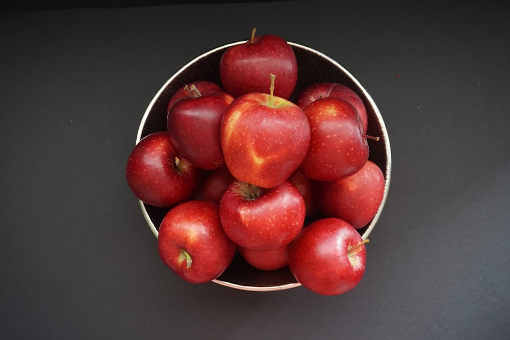 a bowl of red apples