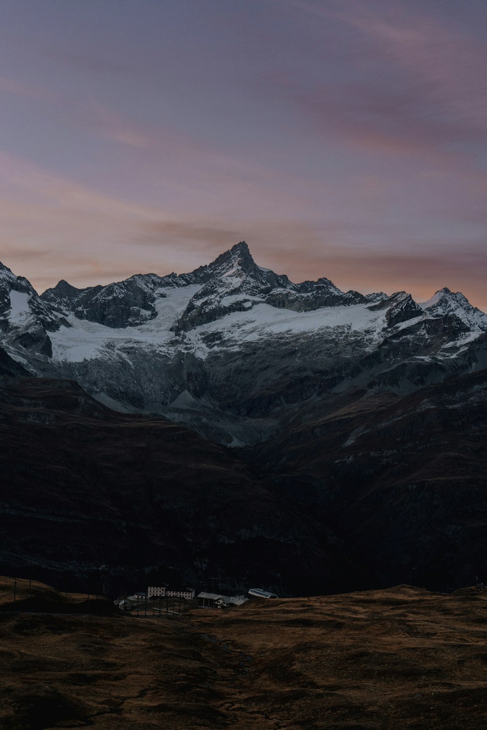 a snowy mountain with a building