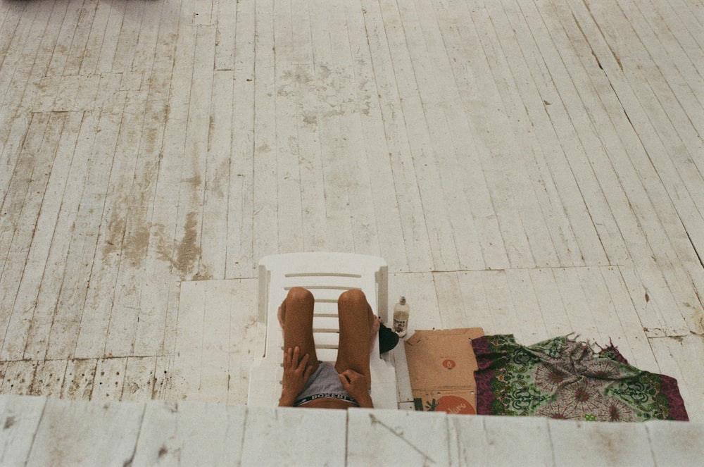 a person's feet in a box on a wood floor