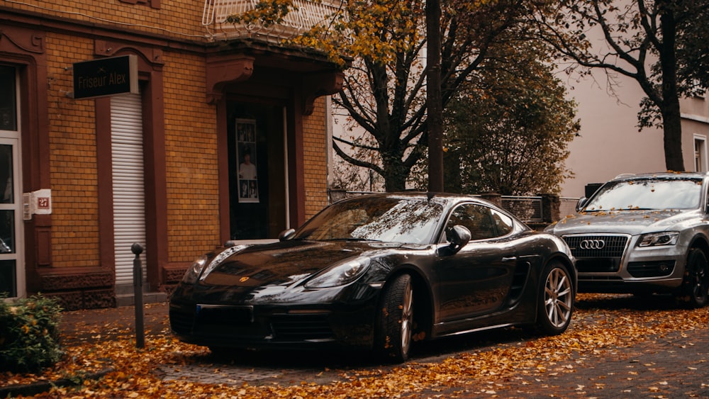 a black car parked in front of a brick building