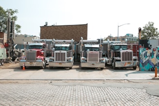 a group of trucks parked on the side of a road