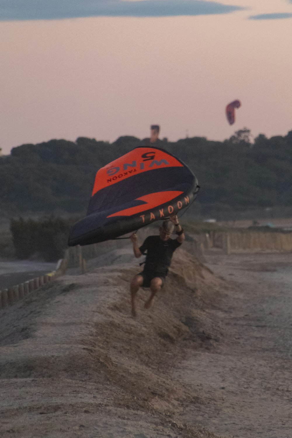 a man carrying a surfboard