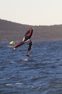 a man is wind surfing in the sea