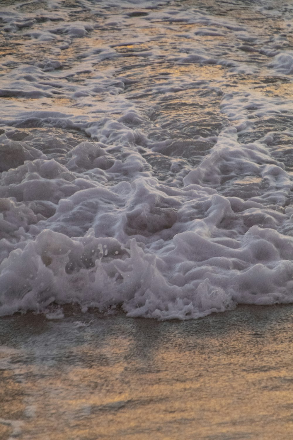 a large body of water with ice and snow on it