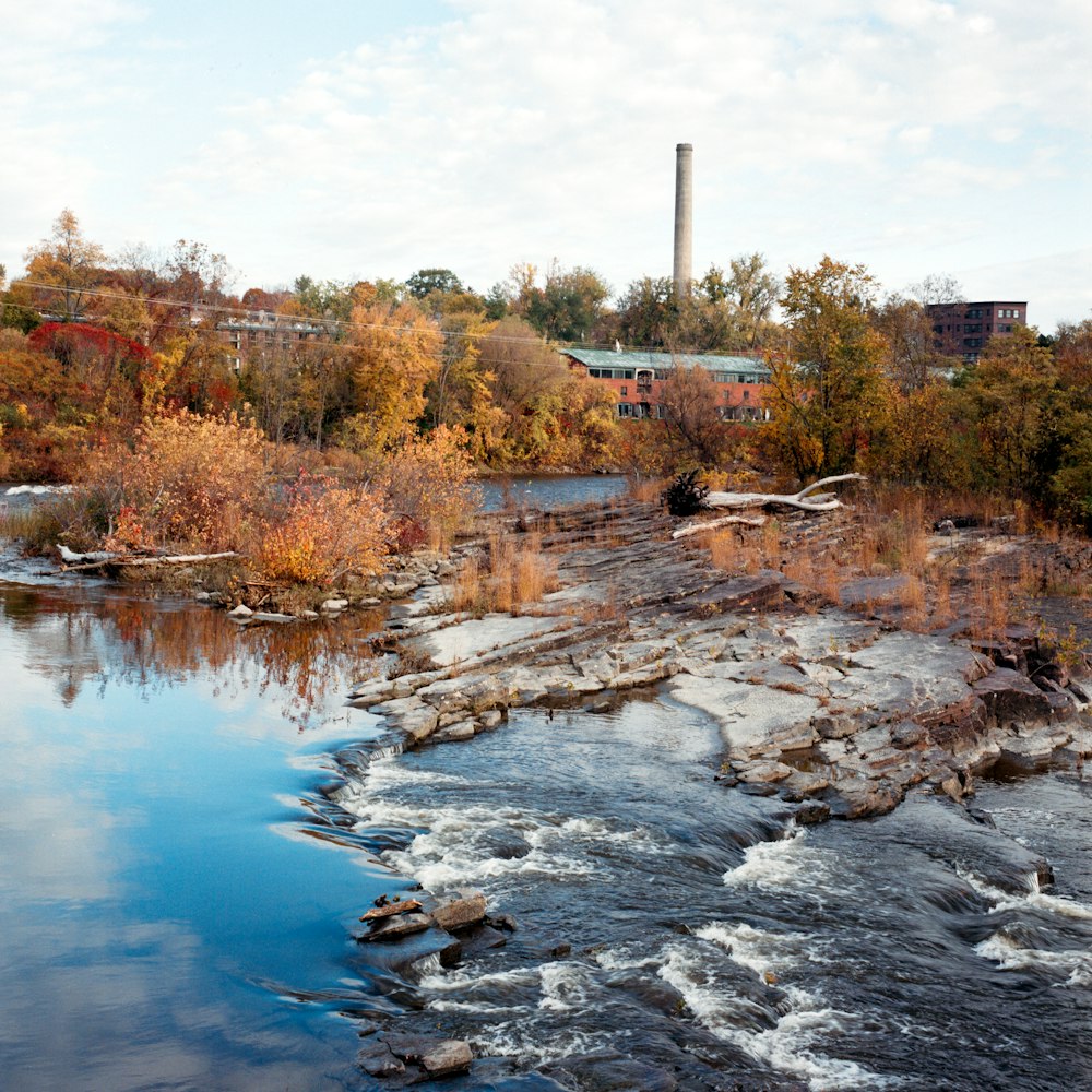 a river with a factory in the background