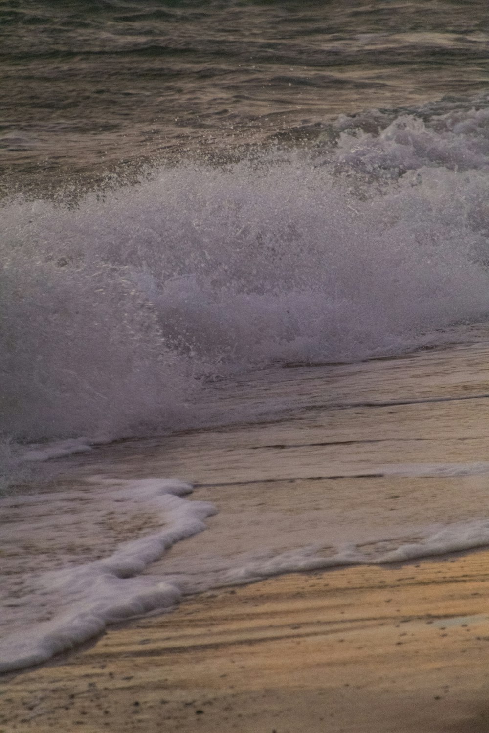 a wave crashing on a beach