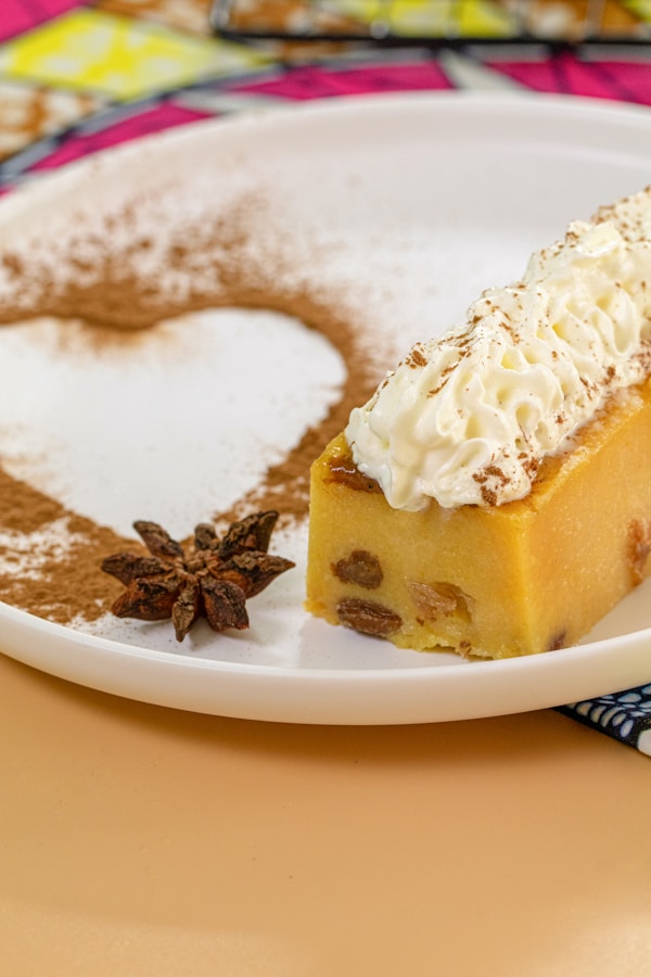A slice of cake with white frosting and a slice of cake
