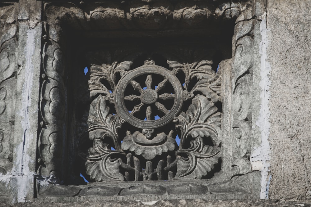 a stone wall with a carved design