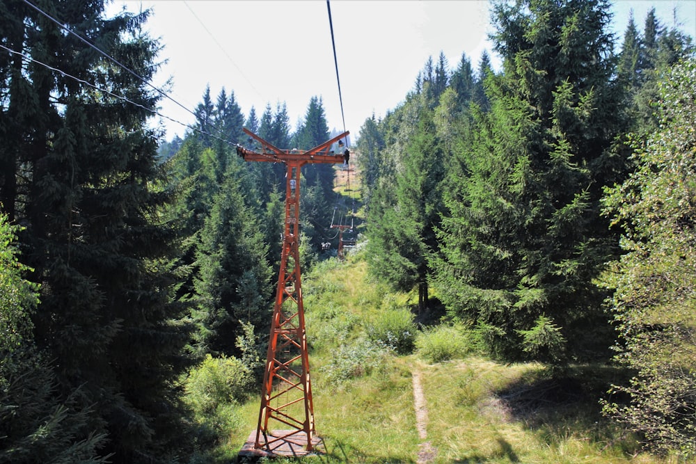 a red tower in the middle of a forest