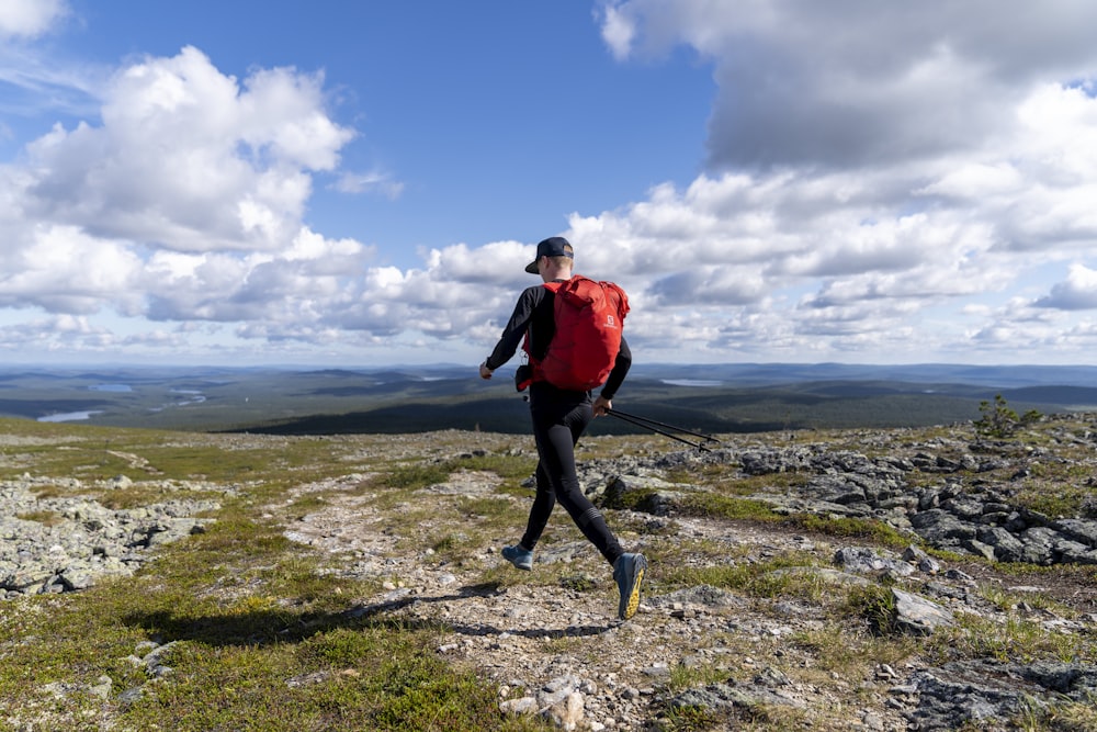 a person walking on a rocky hill