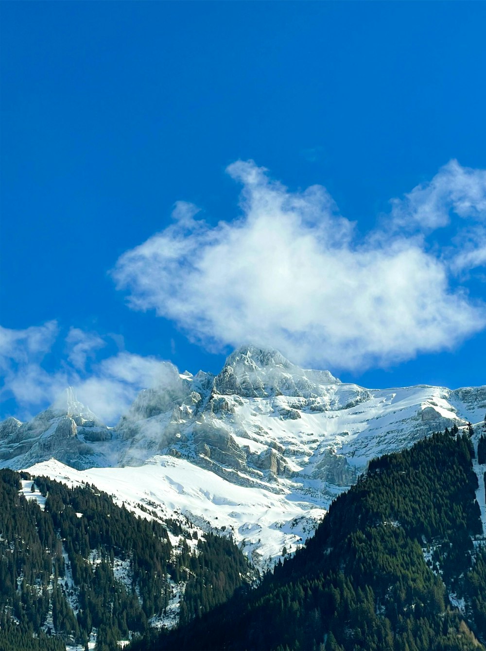 a mountain range with clouds