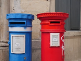 a couple of blue and red mailboxes