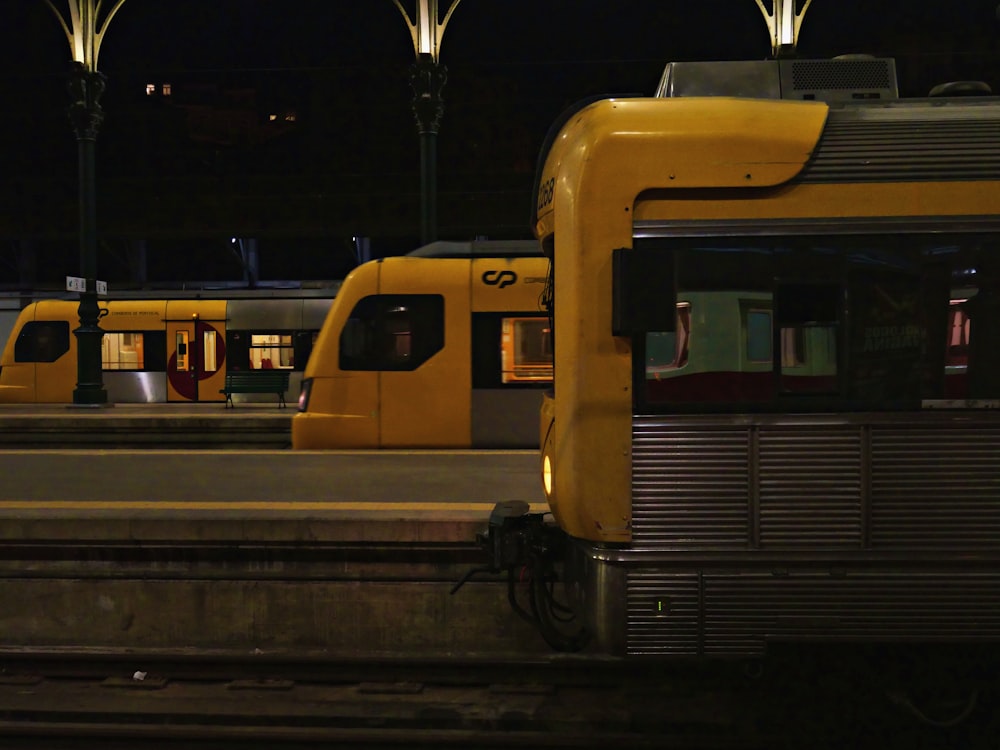 a couple of trains parked at a train station