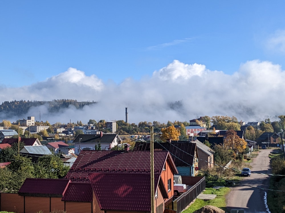 a town with a road and clouds in the sky