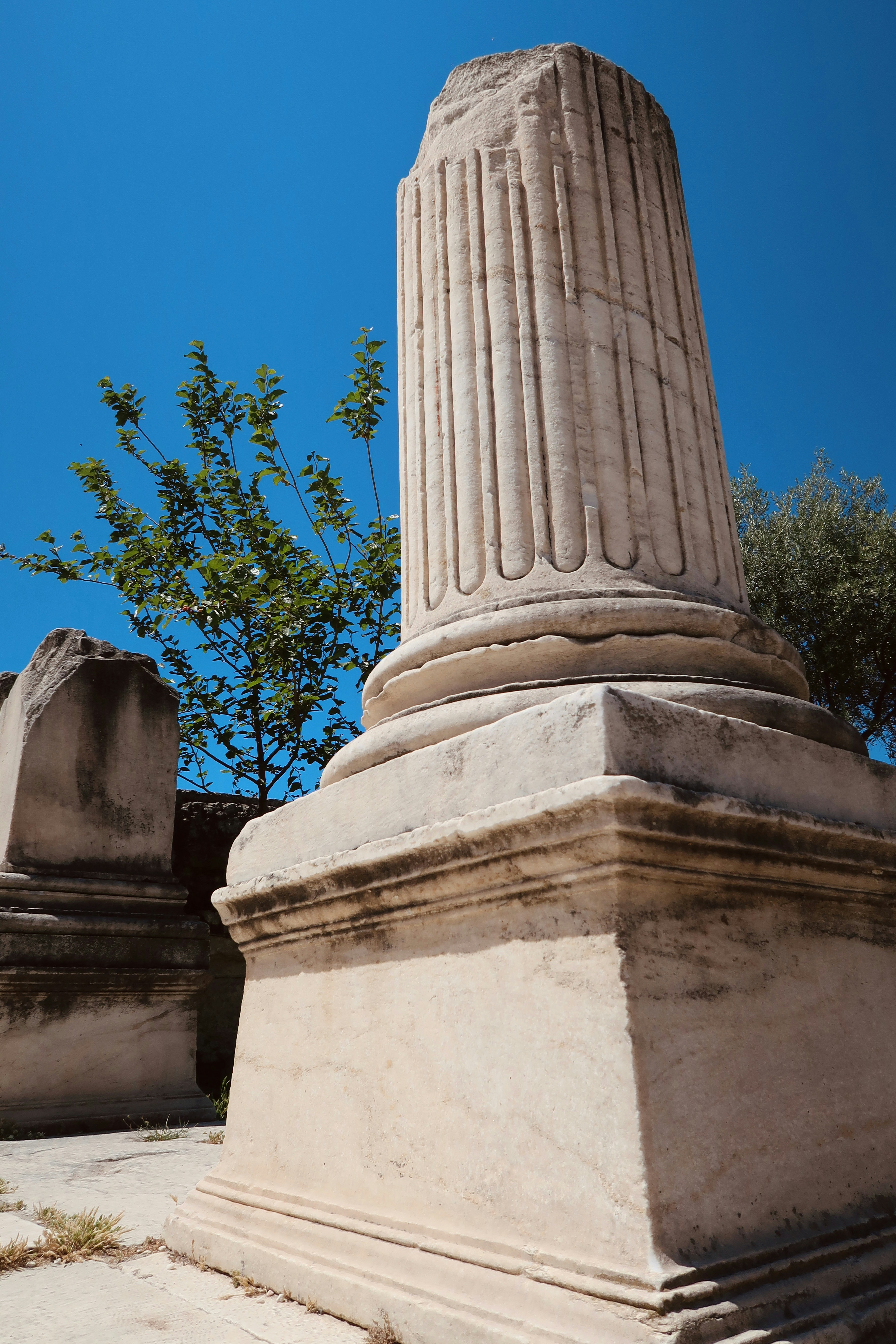 a stone structure with a tree in the background