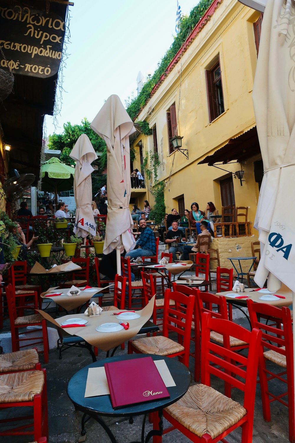 a group of tables and chairs outside a building