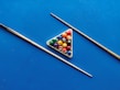 A collection of various billiard cues arranged neatly.