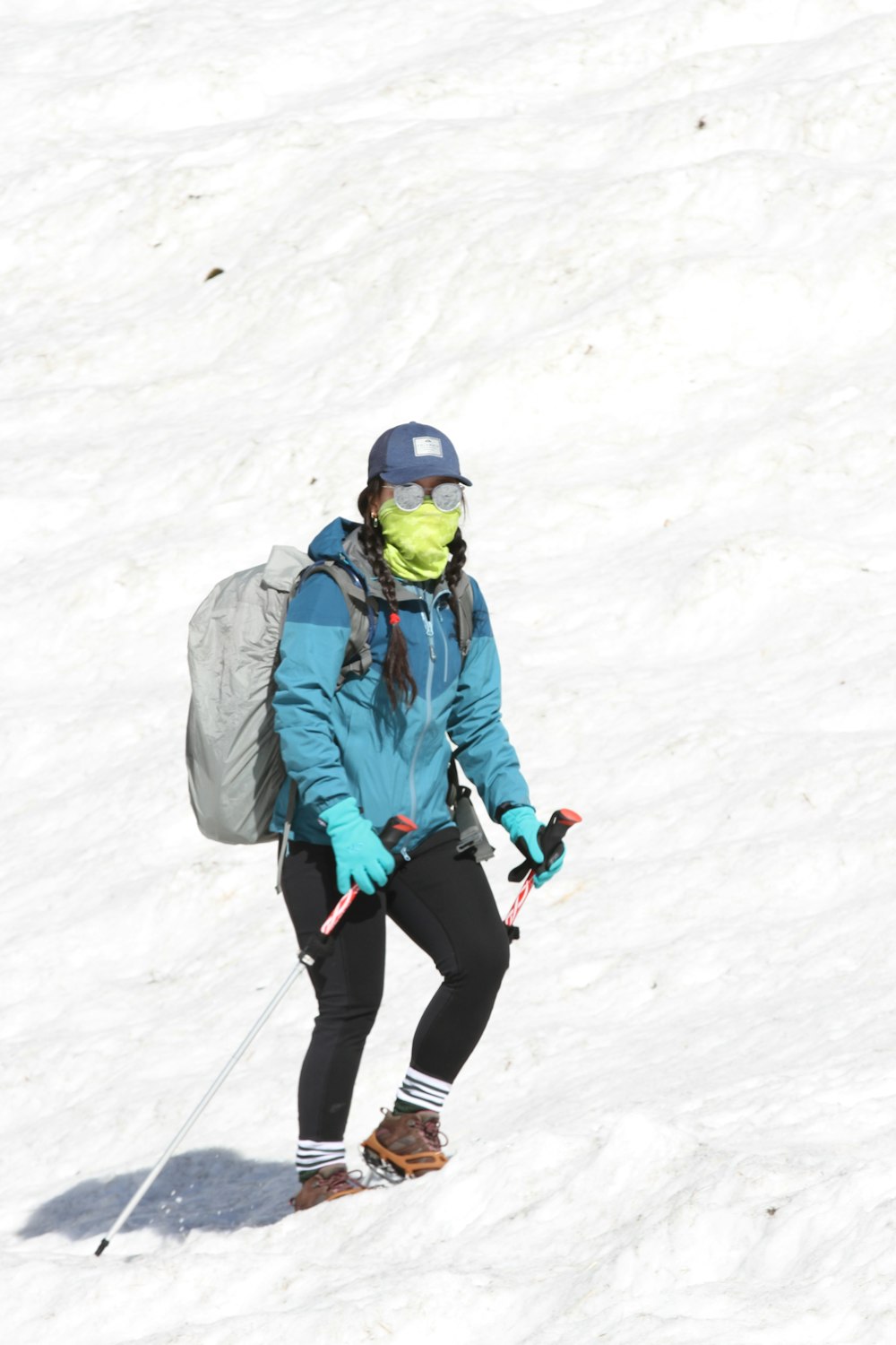 a person with a backpack walking on a snowy mountain